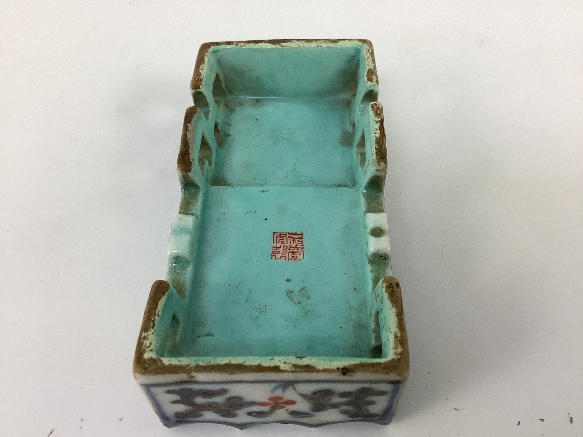 A small Chinese enamelled porcelain brushrest, Jiaqing mark and period (1796-1820), 9cm x 4.5cm, small splinter chip
